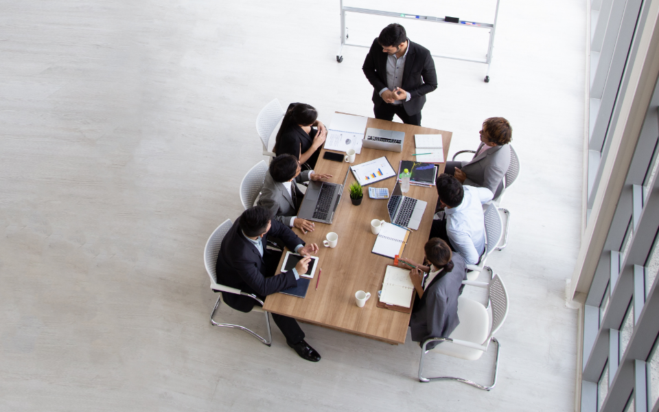 View from above of team working at a conference table.