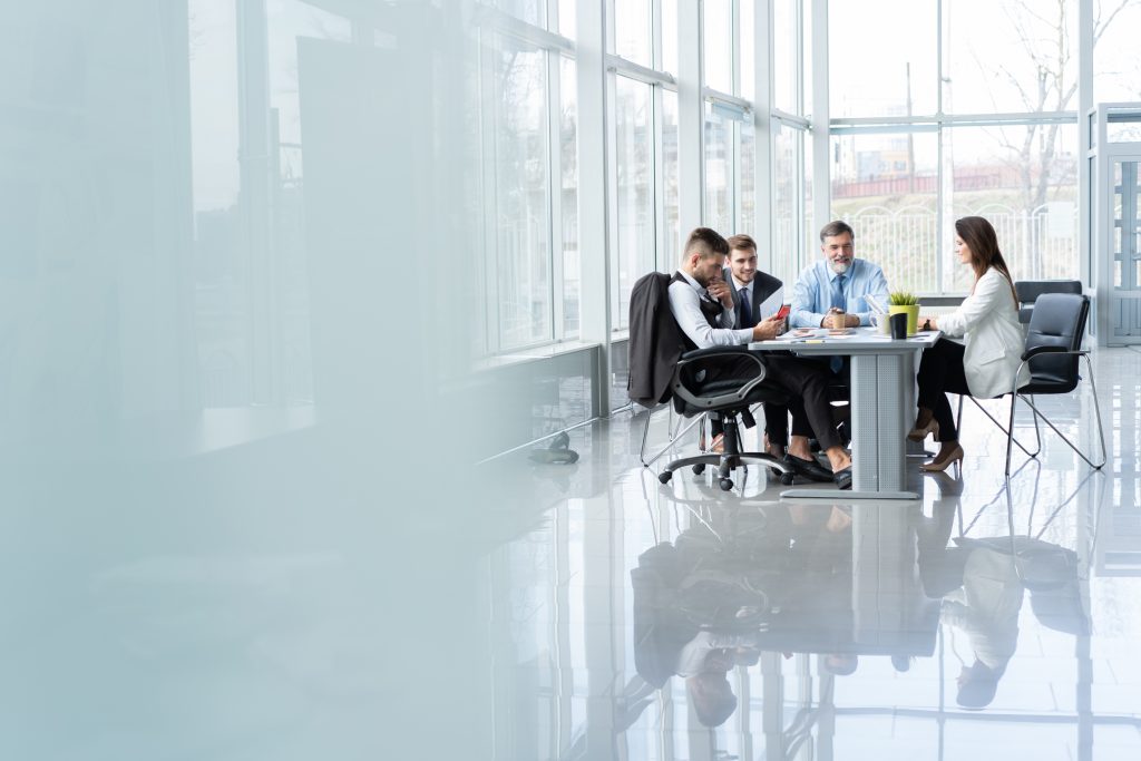 Businesspeople discussing client project in conference room during meeting at office.