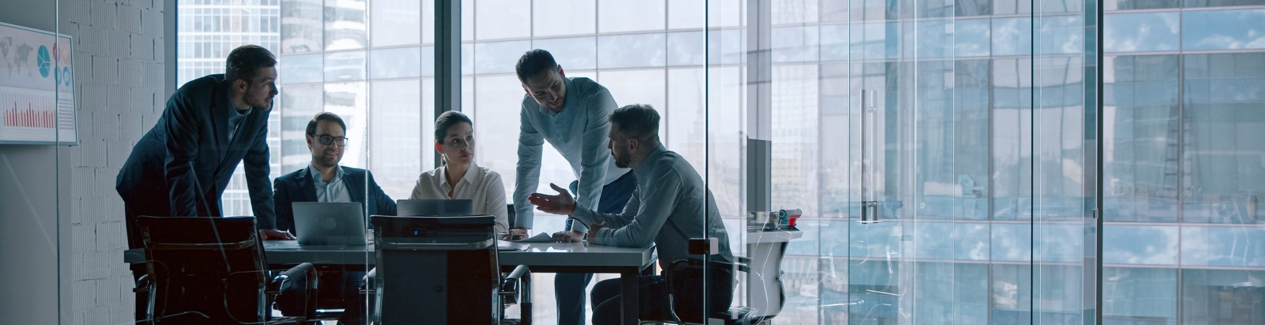 Young professionals having a discussion at a meeting in a modern office building.